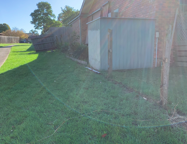 Fence before restoration—weathered boards