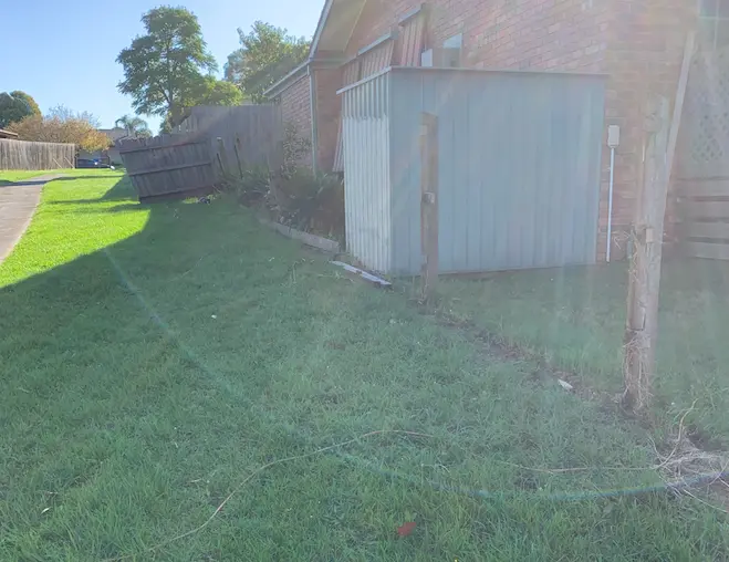 Fence before restoration—weathered boards